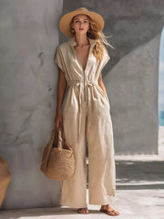 Khaki wide-leg jumpsuit with short sleeves, zipper front, drawstring waist, and collared neckline.