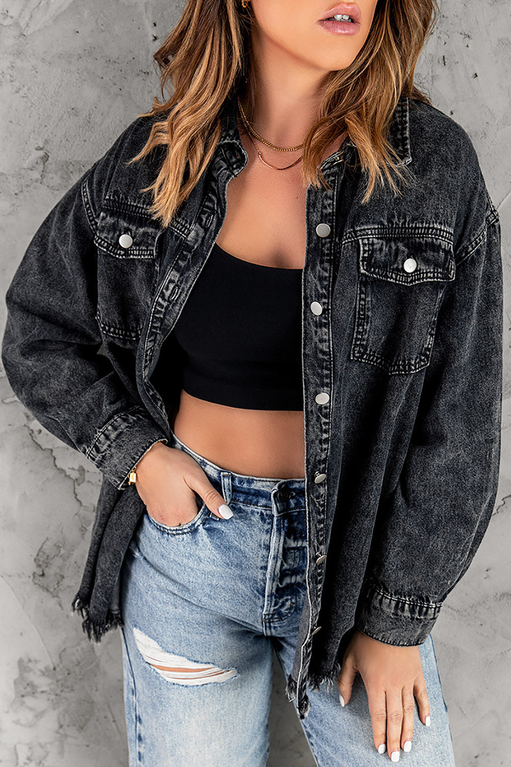 Oversized black denim shirt jacket with frayed hem and button front.