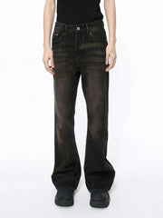 Faded wash bootcut denim jeans in dark with a subtle flare, styled casually.