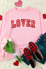 Pink drop shoulder sweatshirt with red "Lover" graphic.