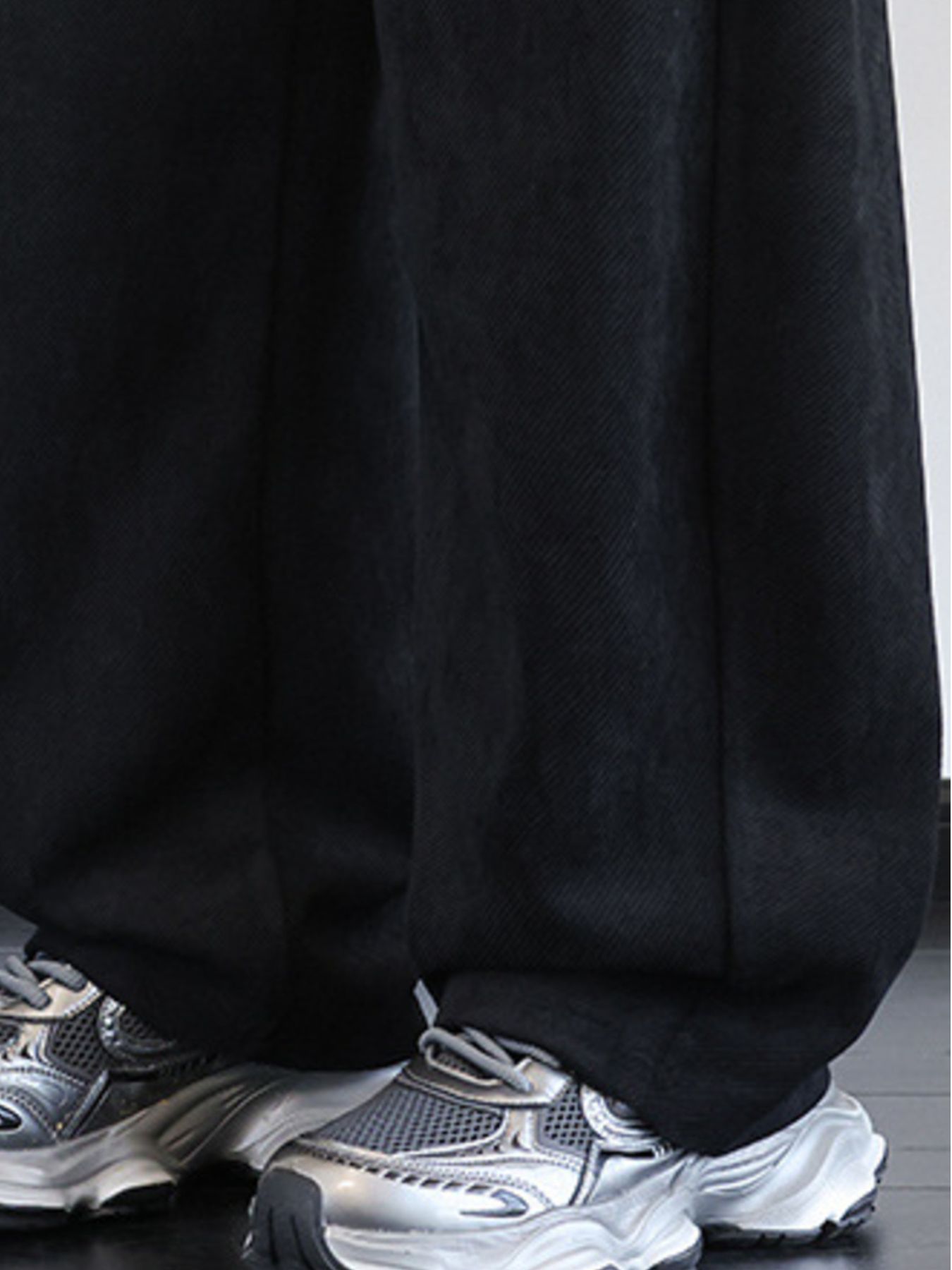 Men's black vintage washed wide leg sweatpants with textured fabric detail.