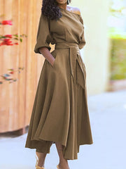 Off-the-shoulder belted dress in camel with puff sleeves and a flowy skirt.