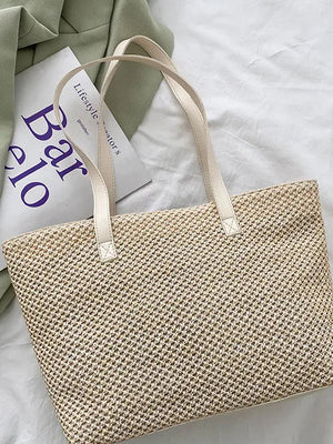 Textured straw shopper bag in beige with leather straps and woven detail.