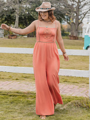 Orange wide leg jumpsuit with embroidered bodice and spaghetti straps.