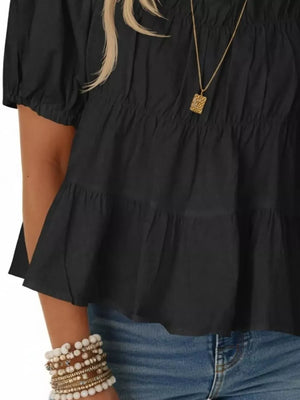 Black maternity blouse with puff sleeves, ruffled tiers, and smocked bodice detail.