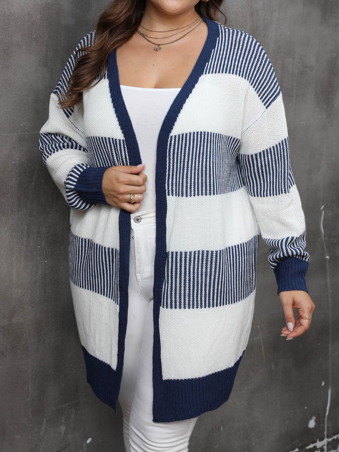 Striped open-front knit cardigan in dark navy and white, 100% acrylic, with a V-neck and long sleeves.