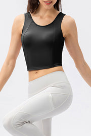 Black active crop top with sculpted seams and scoop neckline.