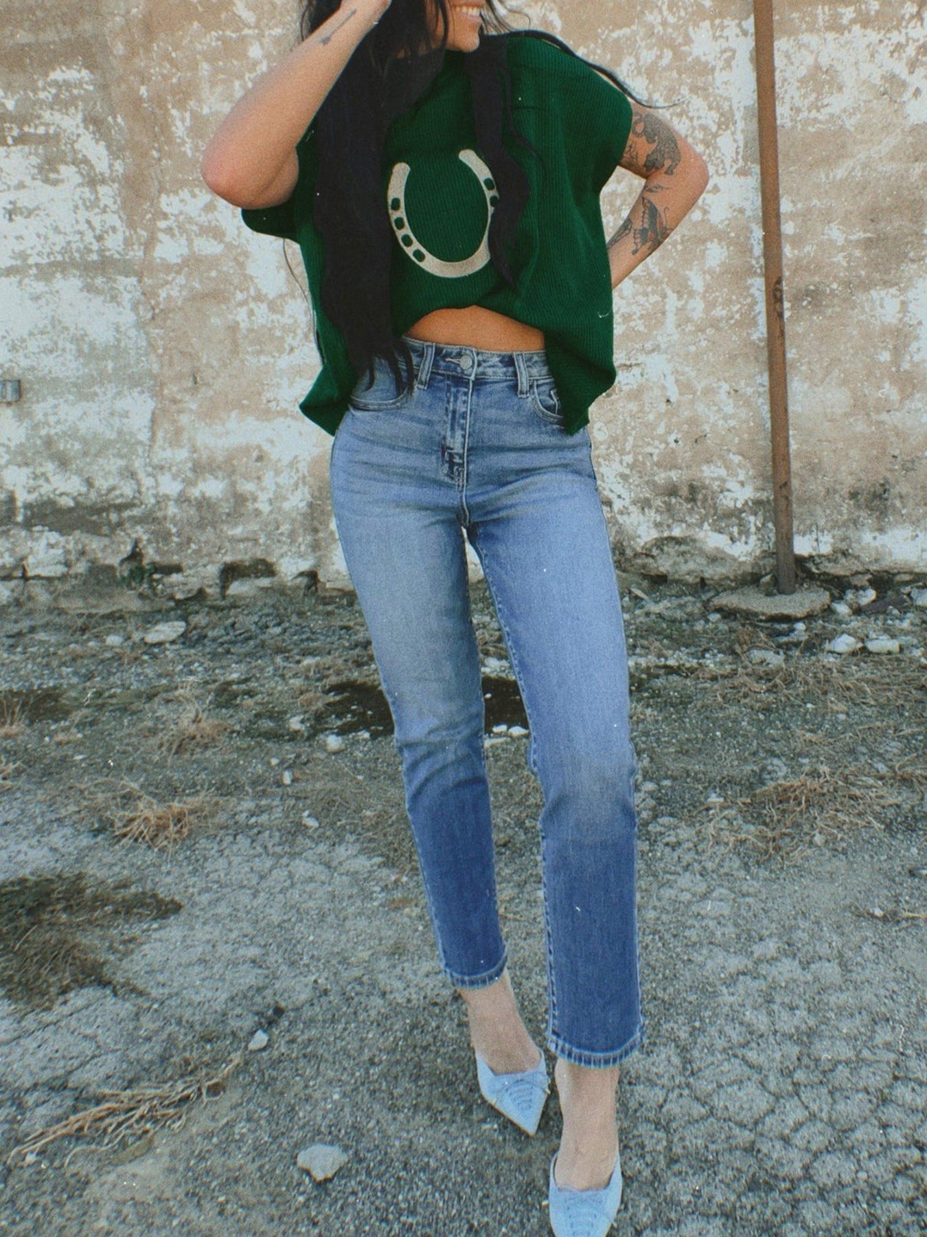 Green ribbed knit sweater with horseshoe graphic, crew neck, and short sleeves.