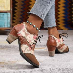 Floral patchwork lace-up ankle boots with brown accents and a block heel.