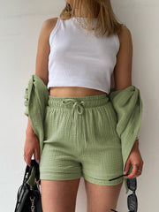 Textured gauze shirt and short co-ord set in blush pink, casual button-up style.