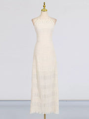 Textured halter neck maxi gown in ivory with smocked details and a ruffled hem.