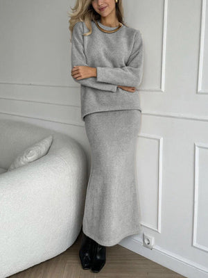 Gray textured knit co-ord set with relaxed fit sweater and maxi skirt.
