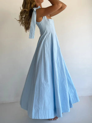 Light blue maxi dress with bow tie shoulder straps and a full skirt.