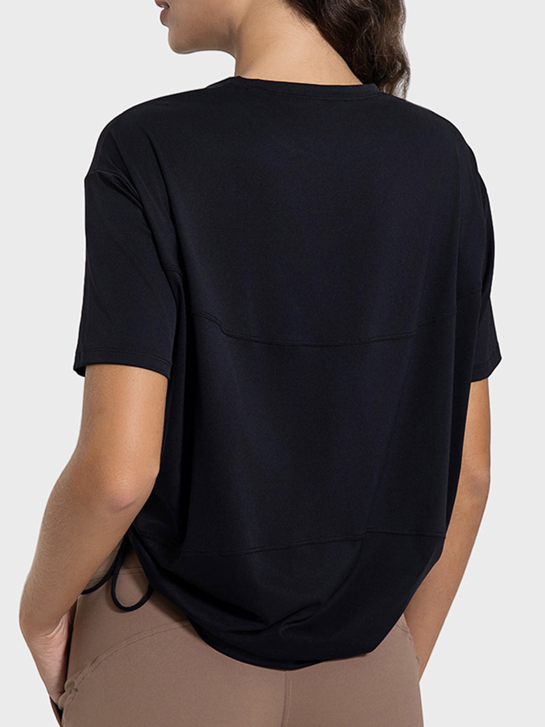 Black jersey t-shirt with short sleeves and a side tie detail.