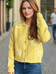 Yellow knit cardigan with pearl embellished snowflake pattern and button front.