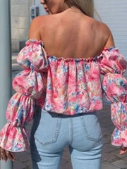 Off-the-shoulder blouse with ruffle sleeves and a floral print in pink and blue.