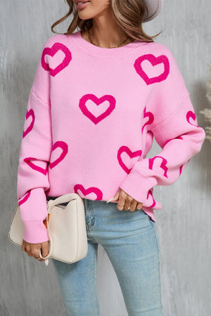 Fuchsia pink acrylic knit pullover sweater with allover heart intarsia pattern and crew neck.