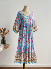 Plus-size light blue floral v-neck tiered maxi dress with bohemian print sleeves and hem.