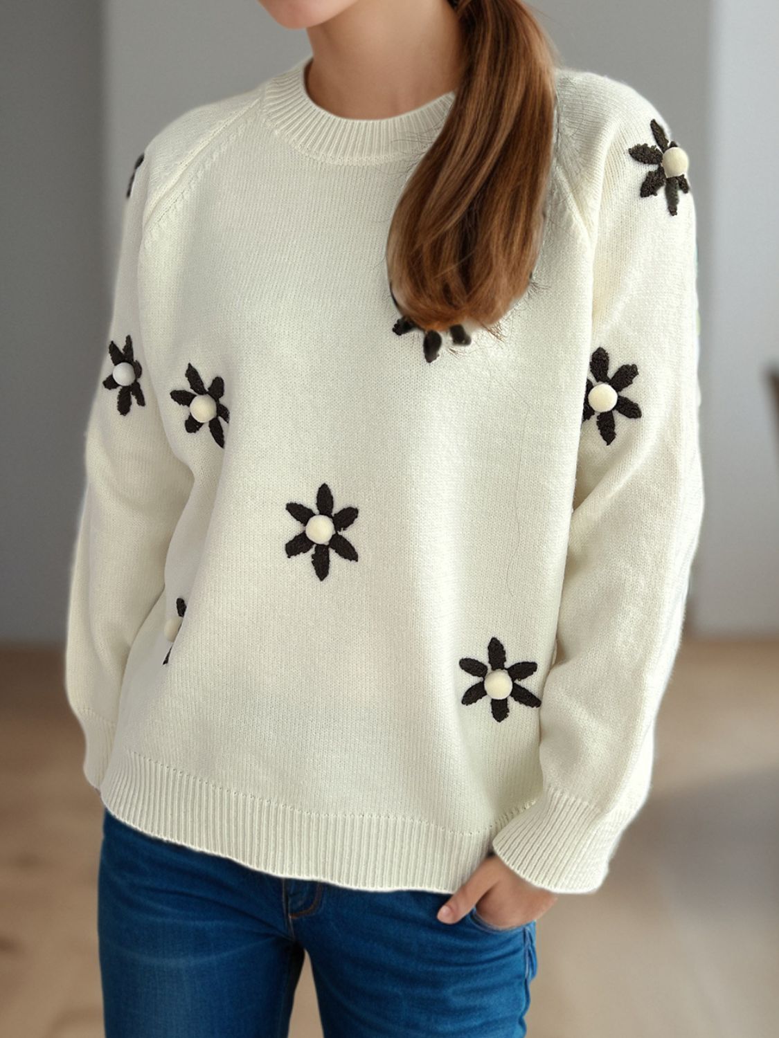 Cream embroidered floral raglan knit sweater with beaded flower details.
