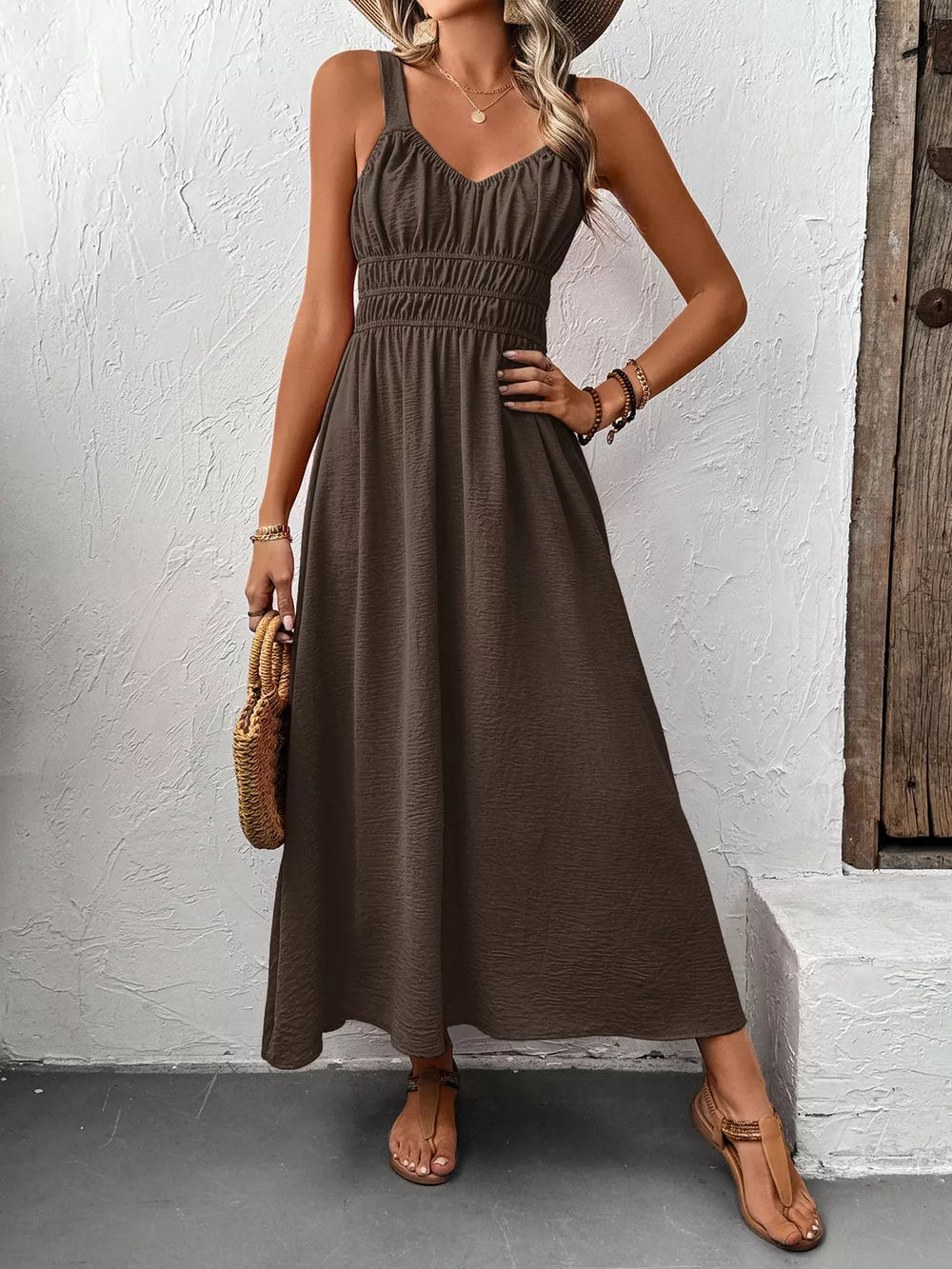 Coffee brown V-neck smocked midi dress with spaghetti straps and a flowy skirt.