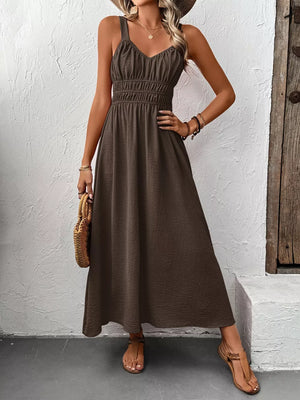 Coffee brown V-neck smocked midi dress with spaghetti straps and a flowy skirt.