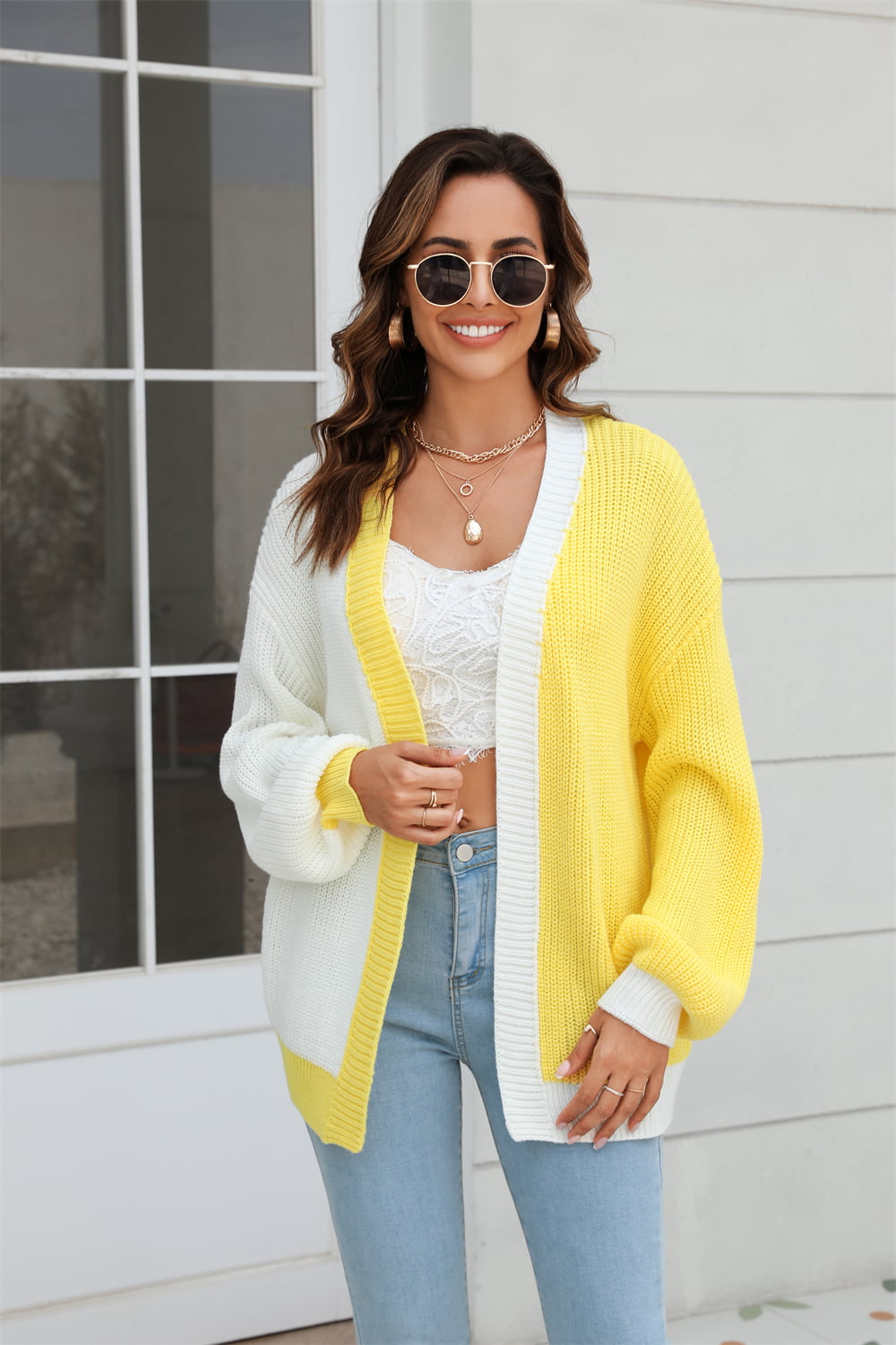 Colorblock knit cardigan with contrast trim in yellow and white acrylic, featuring balloon sleeves.
