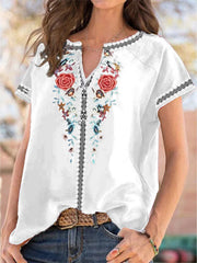White blouse with floral embroidery and notched neckline, short sleeves