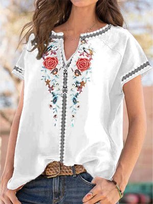 White blouse with floral embroidery and notched neckline, short sleeves