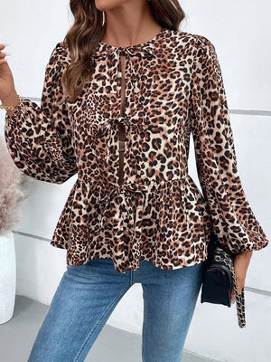 Leopard print peplum blouse with keyhole neckline and tie detail, long balloon sleeves.