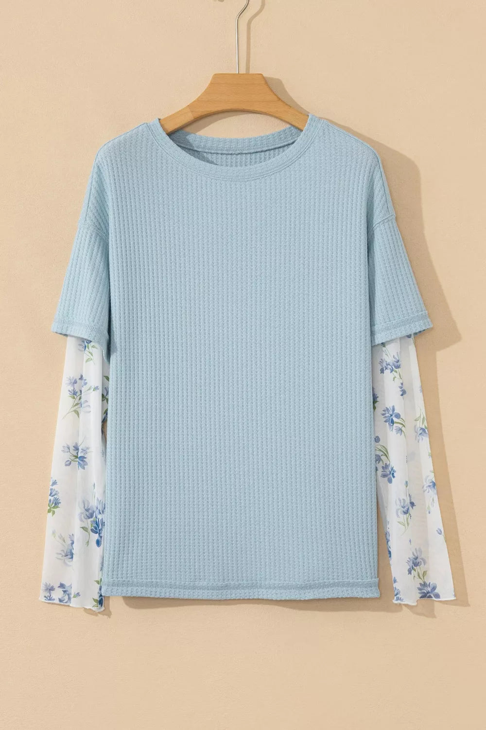 Light blue textured maternity overshirt with sheer floral print sleeves.