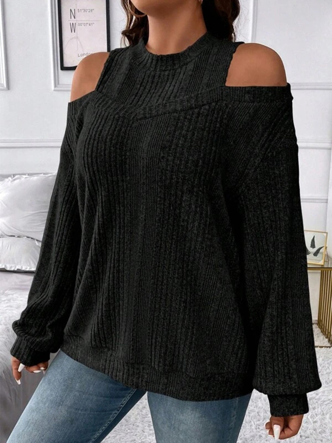 Black ribbed mock neck cold shoulder top with long sleeves.