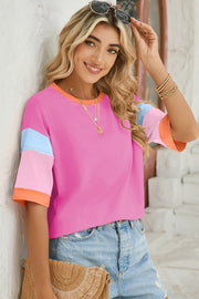 Fuchsia pink crewneck tee with color block sleeves in light blue, pink, and orange.