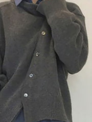 Dark gray acrylic knit cardigan with asymmetric button closure and silver buttons.