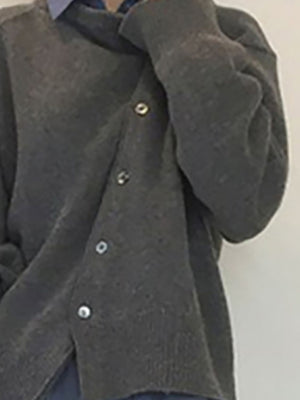 Dark gray acrylic knit cardigan with asymmetric button closure and silver buttons.