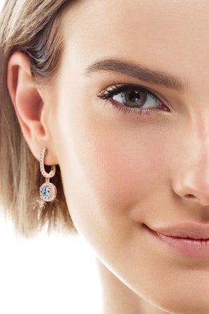 Rose gold pavé halo drop earrings with a central round-cut crystal.