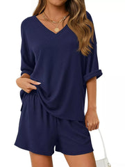 Navy V-neck ribbed knit two-piece loungewear set with cuffed sleeves and elastic waist shorts.