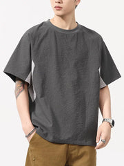 Men's dark gray textured t-shirt with contrast panels and crew neck.