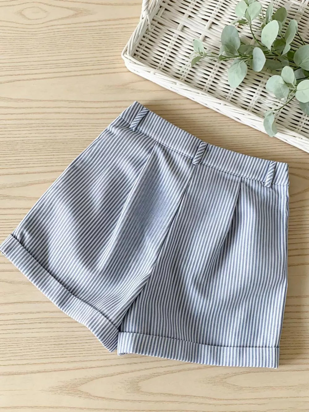 Chic blue and white striped chino shorts with cuffed hems and buttoned waist.