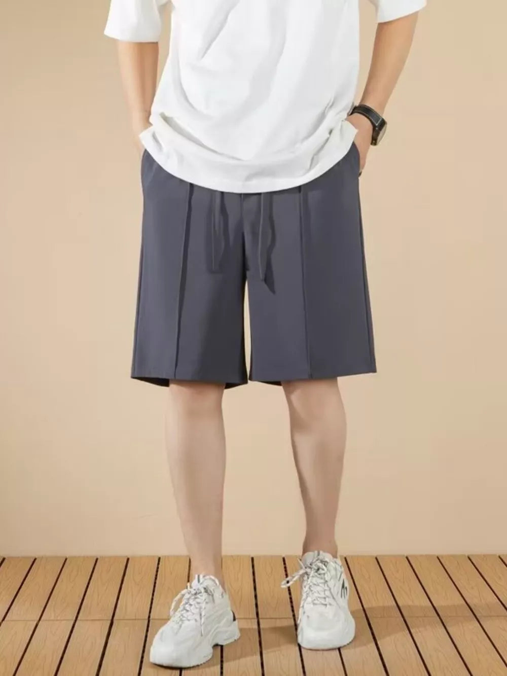 Men's dark gray pleated drawstring chino shorts with a casual fit.