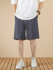 Men's dark gray pleated drawstring chino shorts with a casual fit.