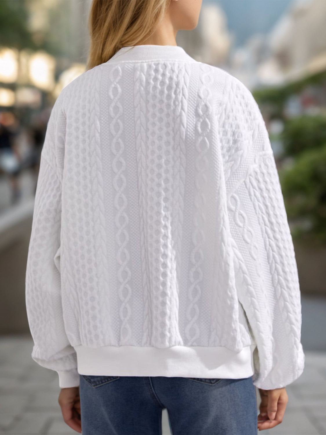 White bomber jacket with textured cable knit and ribbed cuffs and hem.