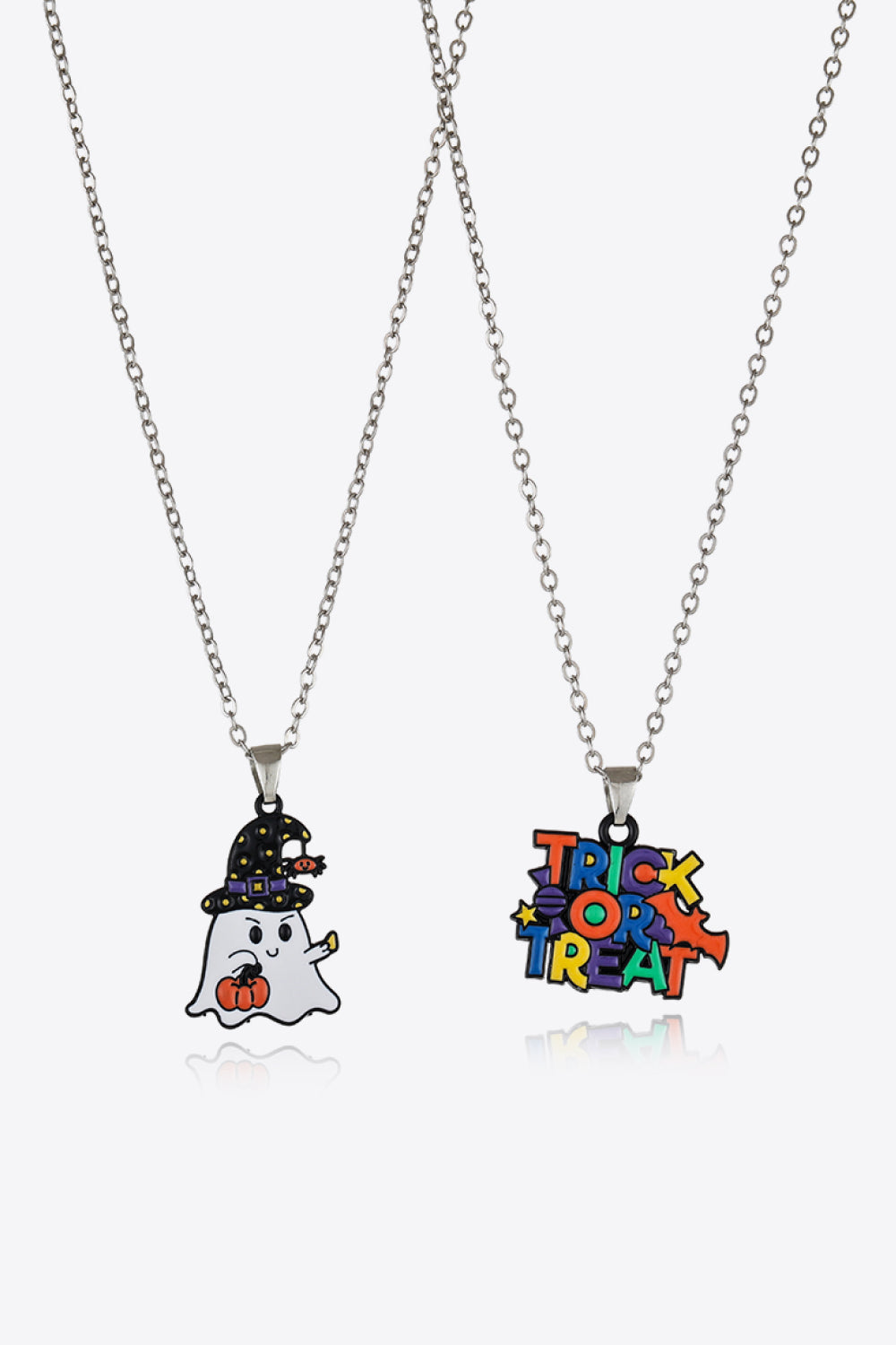 Spooky Season Enamel Pendant Set necklaces, one with a ghost and pumpkin, one with Trick or Treat text.