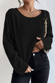 Black ribbed knit off-shoulder top with long sleeves and a scoop neckline.