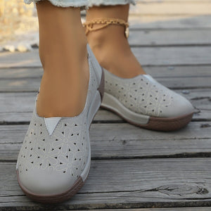 Grey floral cutout slip-on loafers with a comfortable, breathable design.