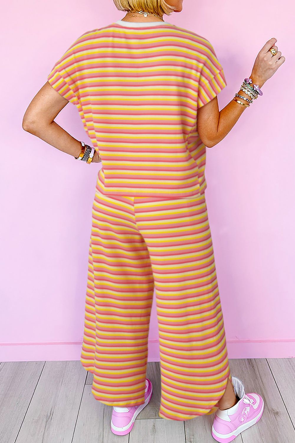 Rainbow stripe culotte jumpsuit in sherbet cotton with drawstring waist and wide legs.