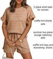 Orange-red waffle knit two-piece set with ruffled sleeves and drawstring shorts.