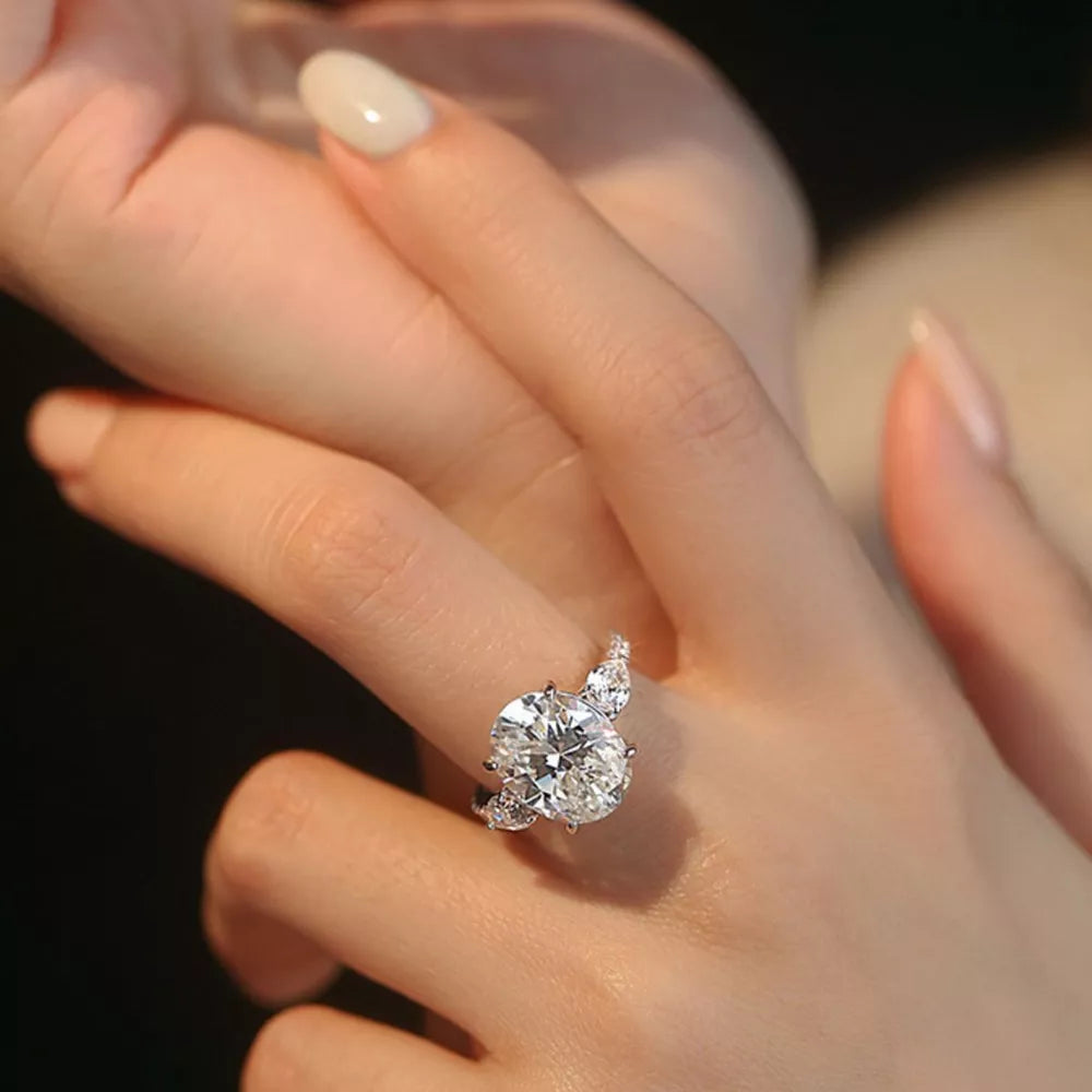 Dazzling Moissanite oval ring in sterling silver with brilliant side stones