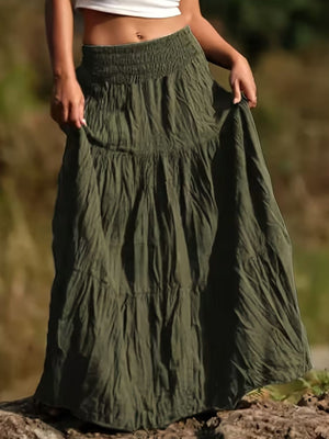 Green tiered maxi skirt with smocked waist and flowing silhouette