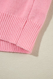 Blush pink knit sweater with ribbed cuffs and hem detail.