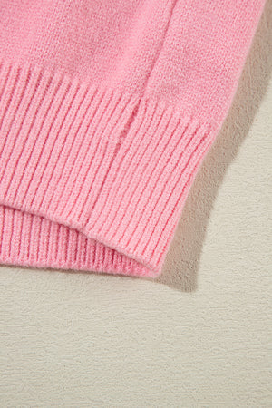 Blush pink knit sweater with ribbed cuffs and hem detail.
